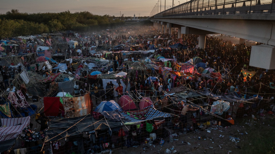 Camp: Thousands of people gather at the border of the Rio Grande River.  The heat is intense and the conditions are very bad.