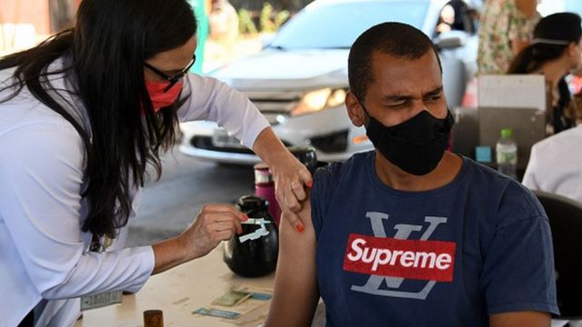 A man receives a vaccine in his arm